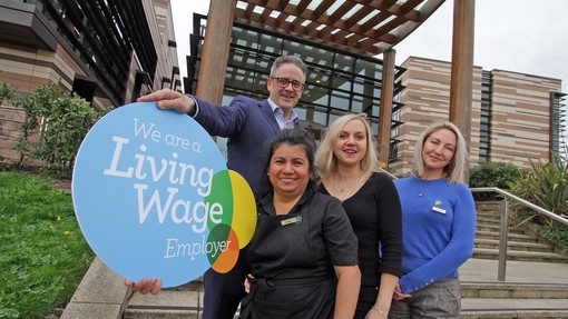 Staff at Nottingham Venues with Living Wage sign